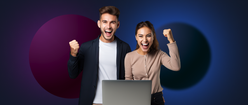 A forex traders, man and woman holding laptops, looking at each other with smiles.